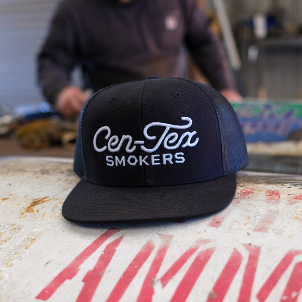 Cen-Tex Smokers black mesh trucker hat with embroidered logo, perfect for barbecue lovers and outdoor grillers.