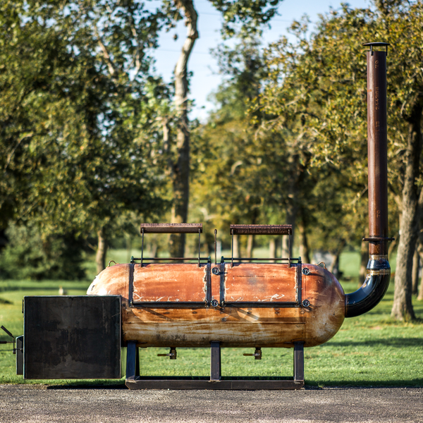 Custom steel offset smoker by Cen-Tex Smokers, featuring reverse flow technology for even heat distribution.